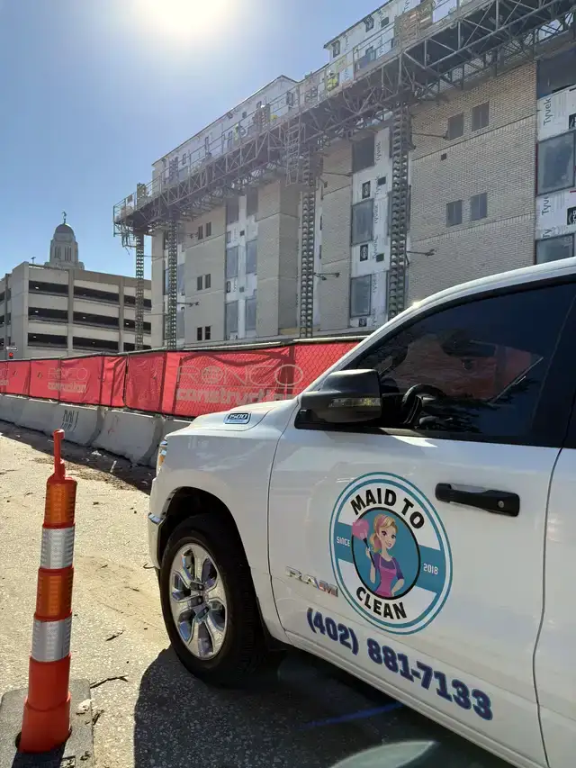 The branded Maid to Clean pickup parked at a construction site